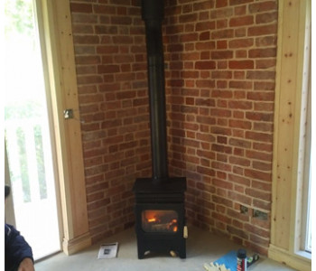 Burley Hollywell Stove - connected to a twin wall thermally insulated chimney system in a timber framed building in the Surrey Hills, near Guildford.